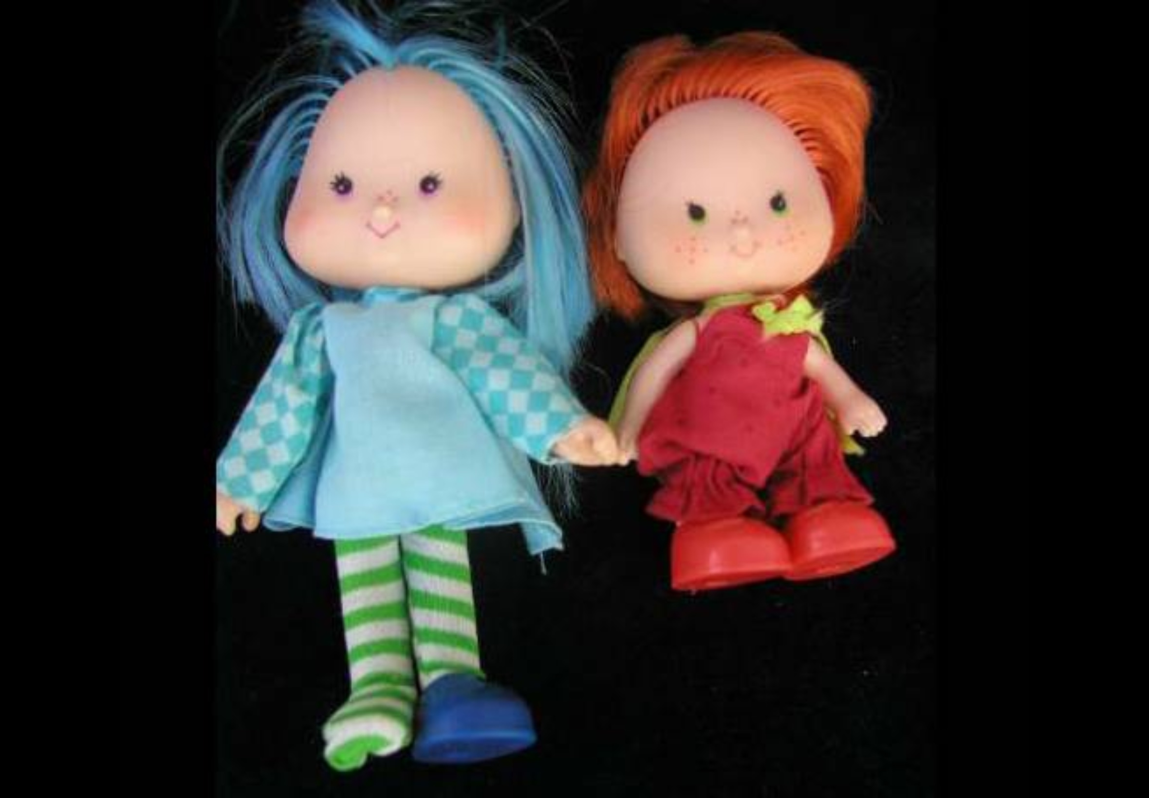 Vintage Blueberry Muffin doll beside an orange-haired doll in red overalls